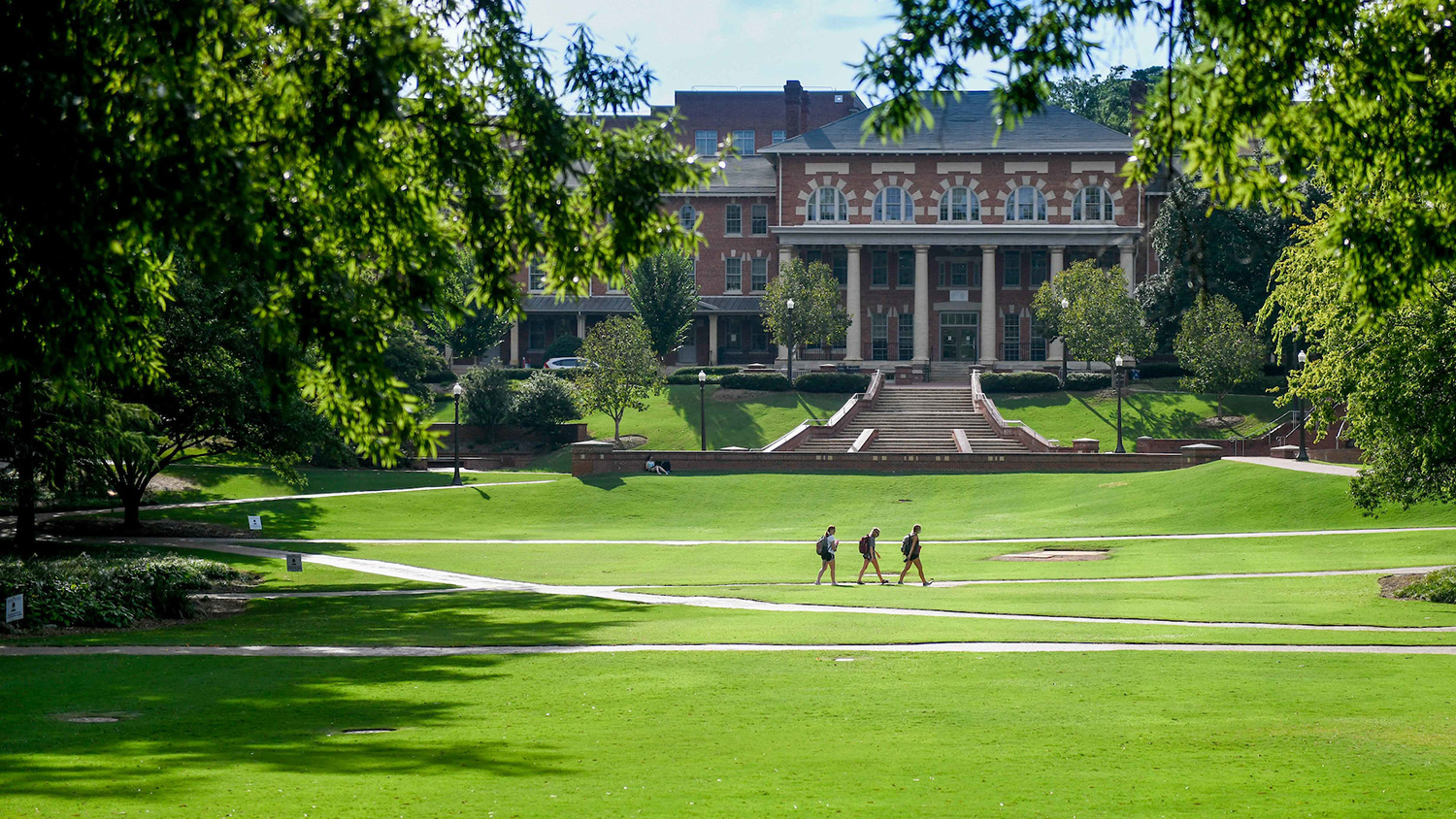 students walk across NC State's campus