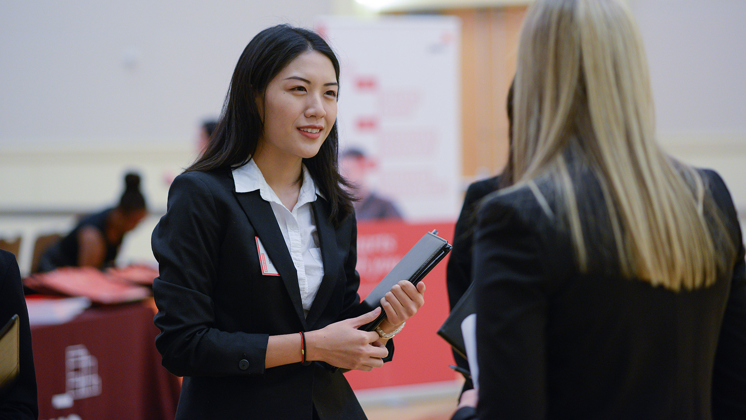A student talks to someone at a job fair